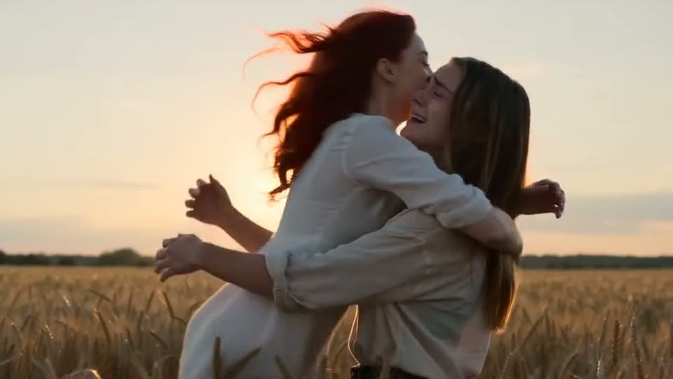 A later frame from the same sample video shows the two fictional characters together in the sunny field